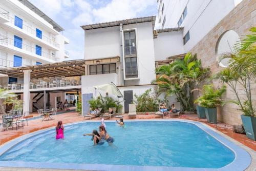 a group of people playing in a swimming pool at Hotel Kinova - Salinas in Salinas