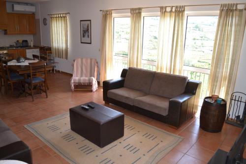 a living room with a couch and a table at Quinta do Santo no Douro - Casa T3 in Alcarias