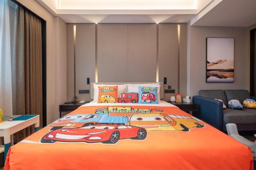a bedroom with a bed with a race car quilt at Atour Hotel Shenzhen Luohu Vientiane City in Shenzhen