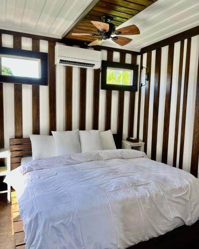 a bedroom with a bed and a ceiling fan at Vacation Village Okinawa - Nakijin in Nakijin