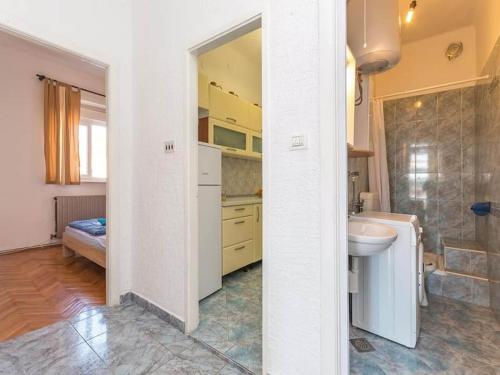 a white bathroom with a sink and a toilet at Apartment Marjan - One Bedroom Apartment with shared Terrace in Posedarje