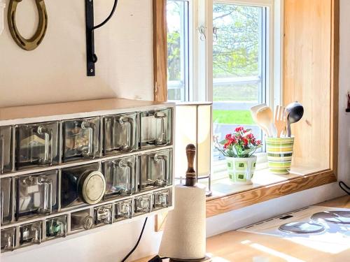 a kitchen with a bunch of pots and pans at 2 person holiday home in ÖDESHÖG in Ödeshög