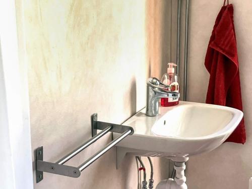 a bathroom with a white sink and a mirror at 2 person holiday home in ÖDESHÖG in Ödeshög