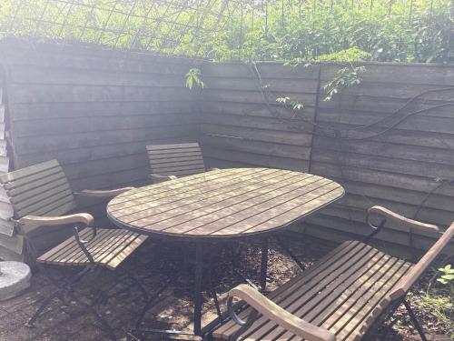a wooden table and two chairs and a table and two chairs at 4 person holiday home in STENINGE in Steninge