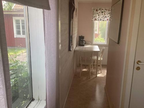 a hallway of a house with a table and a window at 4 person holiday home in STENINGE in Steninge
