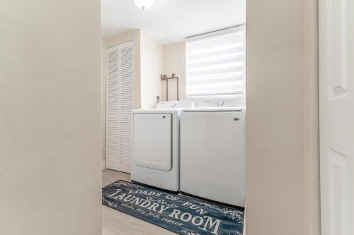 a kitchen with a white refrigerator and a window at Golden Welcome in Hollywood