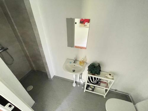 a white bathroom with a sink and a mirror at 5 person holiday home in Stehag in Stehag