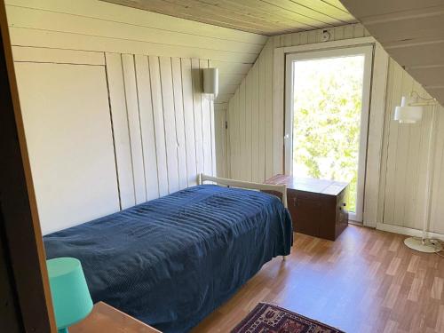 a bedroom with a bed and a desk and a window at 4 person holiday home in ESLÖV in Eslöv