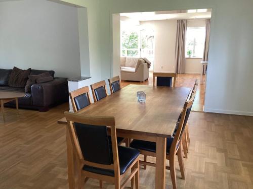 a living room with a wooden table and chairs at 4 star holiday home in Förslöv in Förslöv