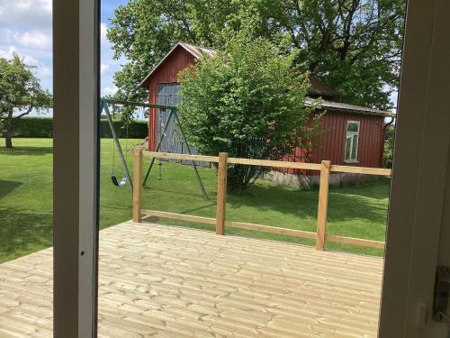 an open door to a porch with a swing at 4 star holiday home in Förslöv in Förslöv