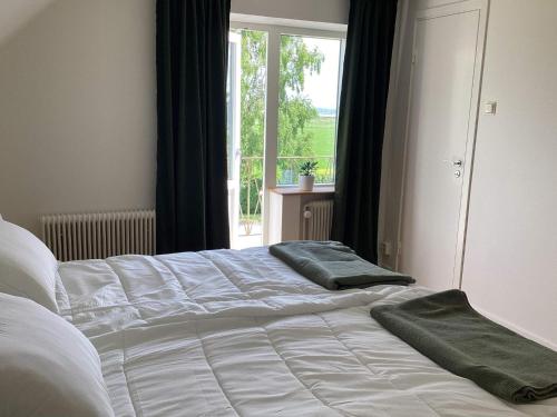 a bed with two green towels on top of it at 4 star holiday home in Förslöv in Förslöv