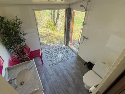 a small bathroom with a toilet and a window at 4 star holiday home in Grimstad in Grimstad