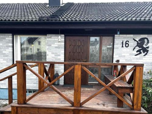 a wooden deck with a wooden door and a house at 4 star holiday home in Ljusne in Ljusne