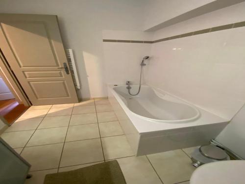 a white bathroom with a tub and a toilet at Villa in France with Private Pool and Garden in Chalais