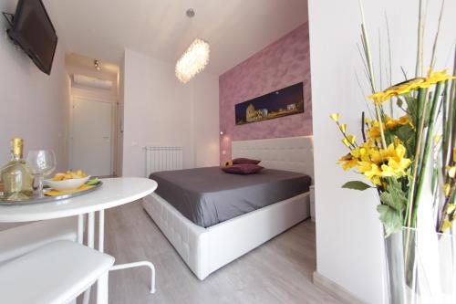 a small bedroom with a bed and a table at Windows on Rome in Rome