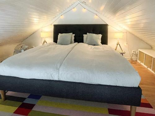 a bedroom with a large white bed in a attic at 7 person holiday home in Mönsterås in Mönsterås