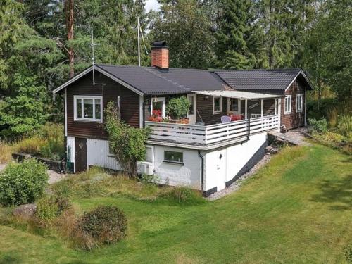 a small house with a porch on top of a yard at 8 person holiday home in Ärla in Malmköping
