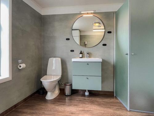 a bathroom with a toilet and a mirror at 4 star holiday home in HALTORP in Halltorp