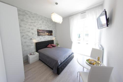 a small bedroom with a bed and a table at Windows on Rome in Rome