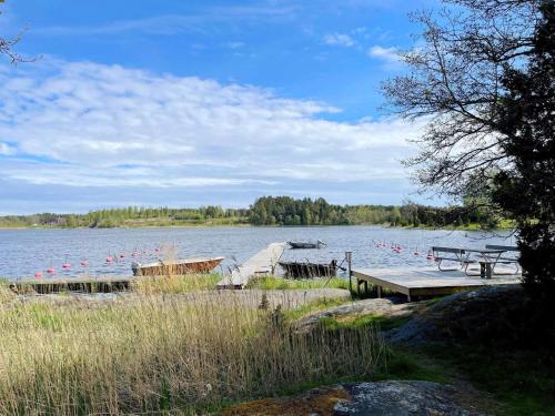 a lake with a dock and a bunch of birds at 5 star holiday home in Gräddö in Gräddö