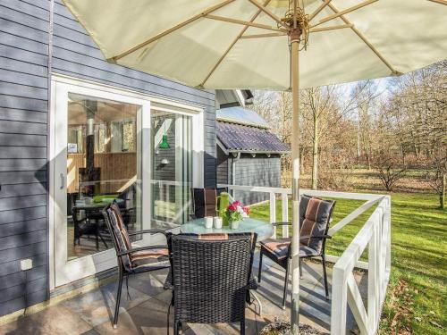a patio with a table and chairs and an umbrella at 4 star holiday home in in Give