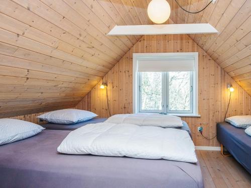 two beds in a attic room with a window at 4 star holiday home in in Give