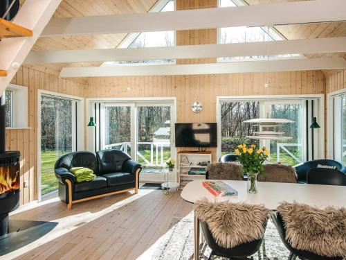 a living room with a couch and a table at 4 star holiday home in in Give