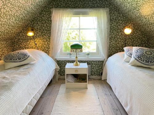 a bedroom with two twin beds and a window at 5 star holiday home in MELLBYSTRAND in Mellbystrand