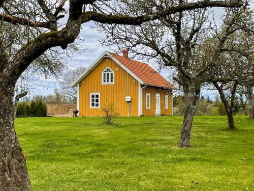 a yellow house in the middle of a green field at 4 star holiday home in HALTORP in Halltorp