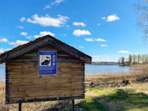 a wooden out house with a sign on it at 4 star holiday home in TVÄRRED in Vasared