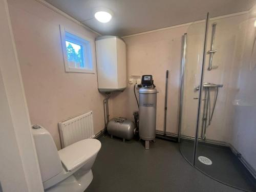 a bathroom with a toilet and a walk in shower at 5 person holiday home in Åryd in Åryd