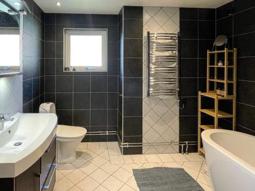 a bathroom with a sink toilet and a shower at 7 person holiday home in Mönsterås in Mönsterås