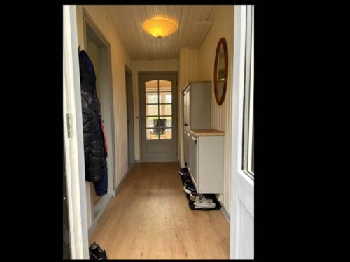 a hallway of a home with a room with a hard wood floor at 6 person holiday home in Herning in Herning
