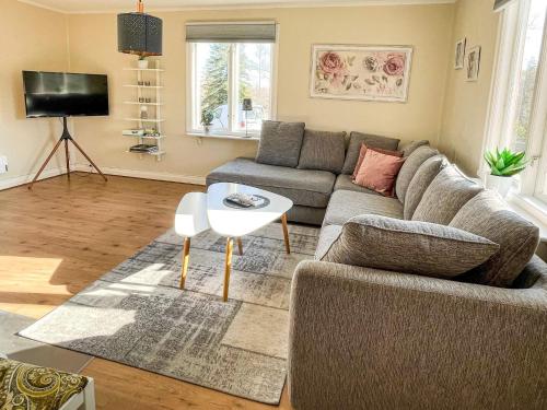 a living room with a couch and a table at 6 person holiday home in Kristdala in Kristdala