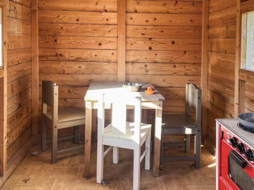 a kitchen with a table and chairs in a cabin at 6 person holiday home in Kristdala in Kristdala