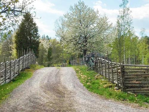 a dirt road next to a wooden fence at 6 person holiday home in Kristdala in Kristdala
