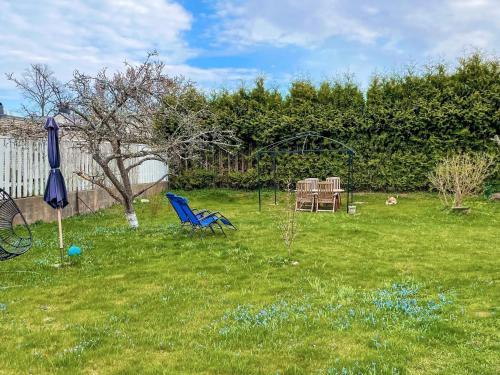 a yard with a table and chairs and an umbrella at 4 person holiday home in Rättvik in Västervik