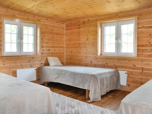 a bedroom with two beds and two windows at 4 star holiday home in KIL in Kil