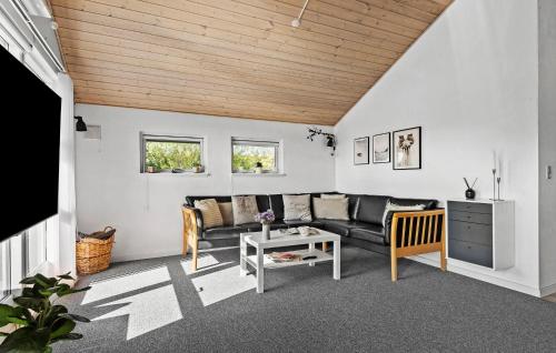 a living room with a couch and a table at 3 Bedroom Cozy Home In Hemmet in Hemmet