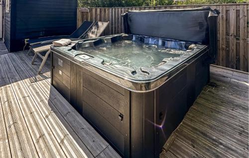 a hot tub sitting on a wooden deck at 3 Bedroom Lovely Home In Kalundborg in Kalundborg