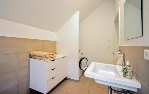 a white bathroom with a sink and a mirror at Awesome Home In Lautenthal With Sauna in Lautenthal