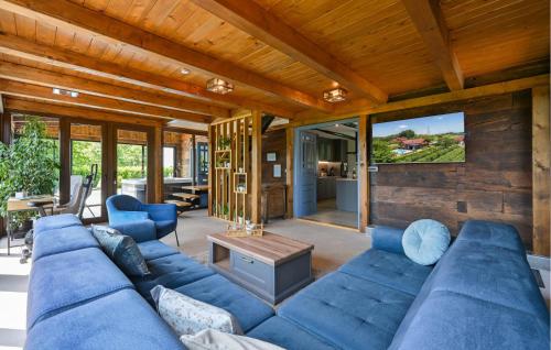 a living room with a blue couch and a tv at Gorgeous Home In Stubicke Toplice in Stubicke Toplice