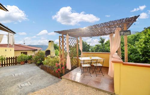 a patio with a table and a pergola at 3 Bedroom Cozy Home In Camaiore in Camaiore