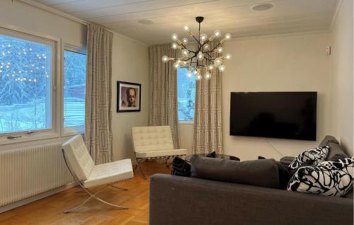 a living room with a couch and a flat screen tv at 3 Bedroom Amazing Home In Grängesberg in Grängesberg
