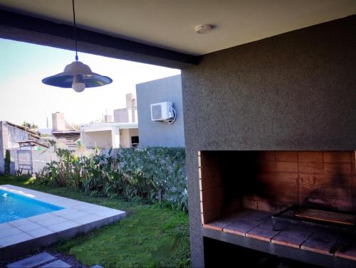 a house with a brick fireplace next to a swimming pool at Funes Inn in Funes