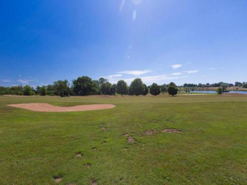 a golf course with a green field with a hole at Luxury Villa in France with Pool and Garden in Vasles