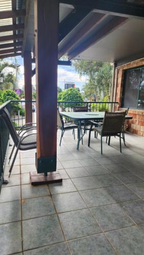 a table and chairs on a patio with a table and a ping at T's Resort & Motel in Port Macquarie