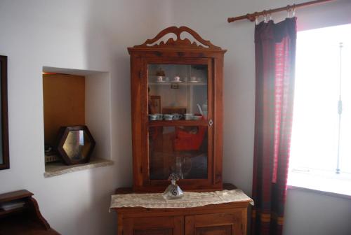 a large wooden cabinet in a corner of a room at To Archontiko tis Anastasias in Athienou