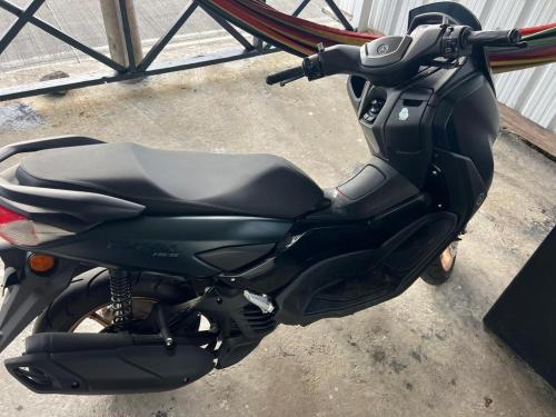 a black motorcycle parked next to a building at Posada Black Pearl in Providencia