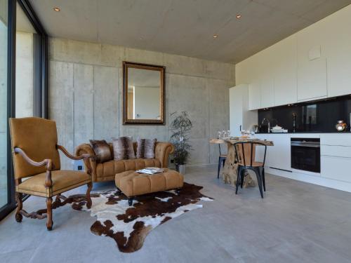 a living room with a couch and chairs and a table at Cozy Villa in Dalhem Ardennes with Private Garden in Dalhem
